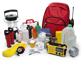 Emergency kit supplies including water, duct tape, a flashlight, canned food and a radio.