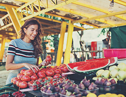 A woman at a farmers market stall.