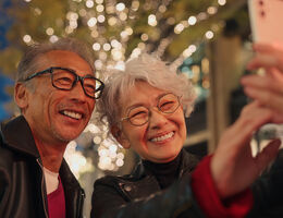 An older couple taking a selfie.